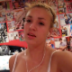 A girl video-records herself peeing on the toilet while on her iPhone with her friend.